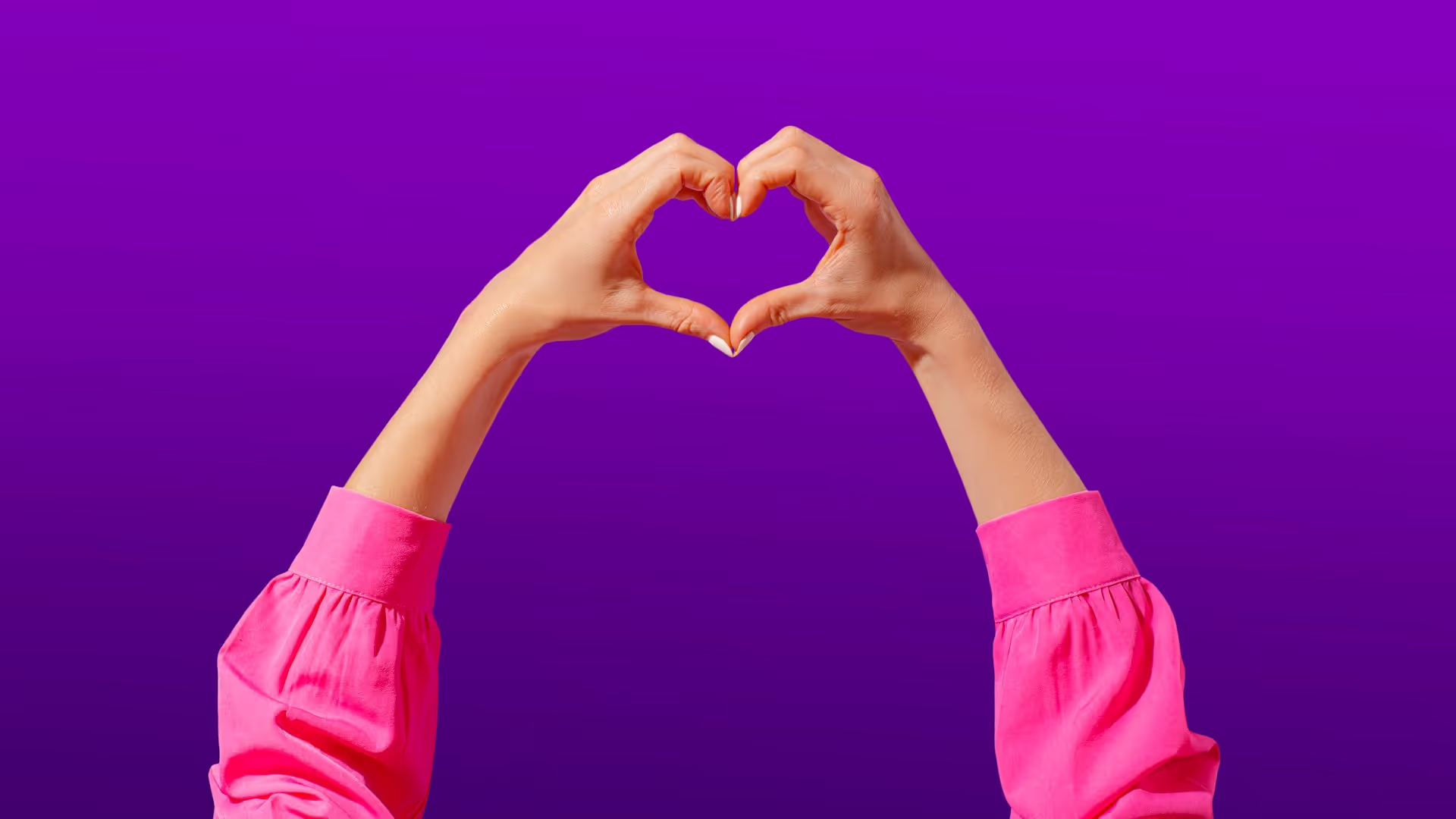 Person shaping hands into a heart.